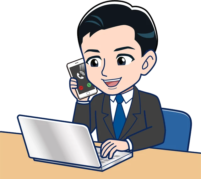 パソコンの前で電話に出る制作担当